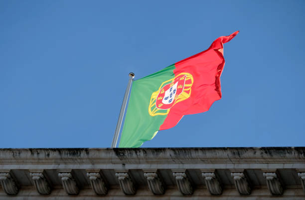 istock Portuguese flag in the wind against a clear sky 1493958693
