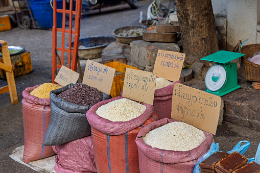 Morning market, Luang Prabang, Laos - March 15th 2023: Small shop selling rice at the famous morning food market in Luang Prabang which used to be the capital on Laos