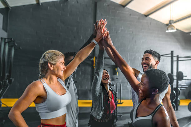 istock Cheerful group of friends doing high five in gym 1493960006