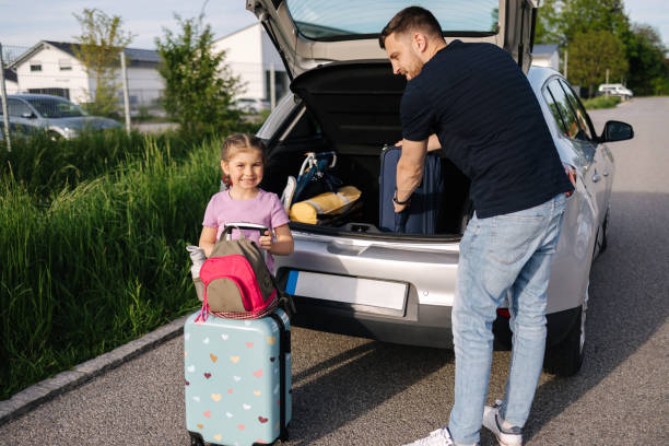 istock Father help daughter loading to the trunk with luggage before traveling while mom packs her luggage 1493966088