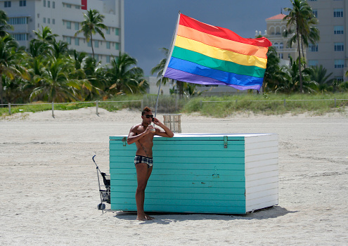 Miami, FL, USA-August 28,2009:Unidentified Guy standing by the Pride Flag at South Beach Miami