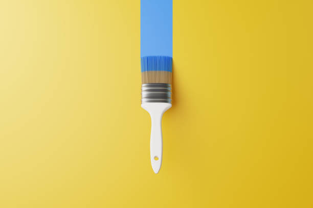 istock Paint brush with blue stripe on a yellow background 1493968858