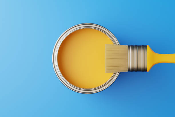 istock An open can of paint and a brush on a blue background 1493968882