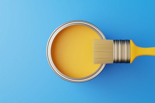 An open can of paint and a brush on a blue background. Top view. Repair concept. 3d rendering illustration