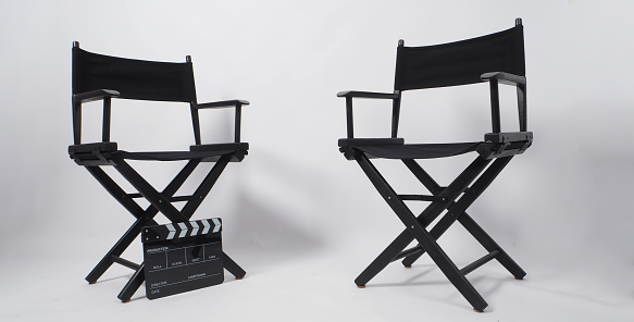 Two Black director chair and clapperboard on white background.