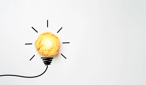 istock Yellow scrap paper ball with illustration painting for virtual lightbulb. It is creative thinking idea for problem solving and innovation concept. 1493969225