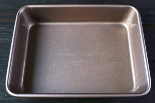 istock Closeup of Greased Cake Pan Ready for Pouring Cake Batter 1493970918