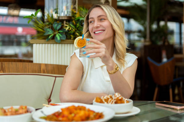 istock Woman drinks ice cold refreshing lemonade in restaurant 1493972290