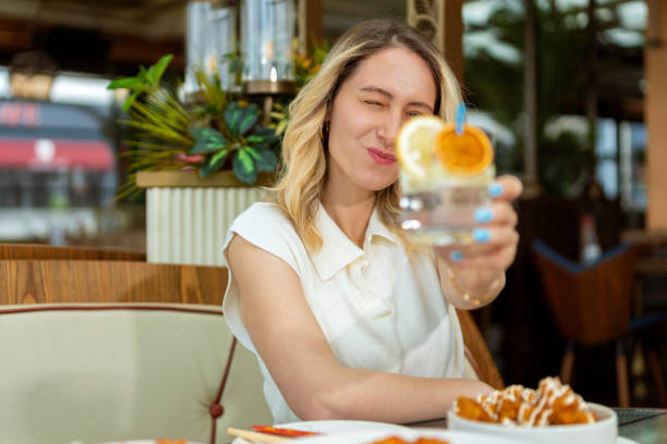 istock Woman drinks ice cold refreshing lemonade in restaurant 1493972358