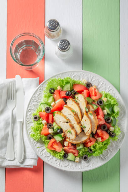 istock Homemade Caesar salad with tomatoes and olives and lettuce. 1493976784