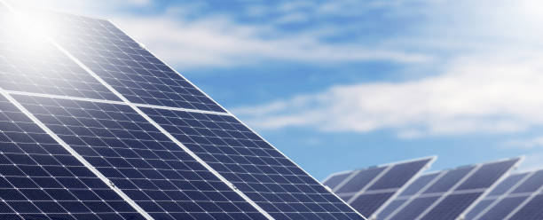 istock Renewable solar energy farm, big solar panels in a row against blue sky. 1493977360