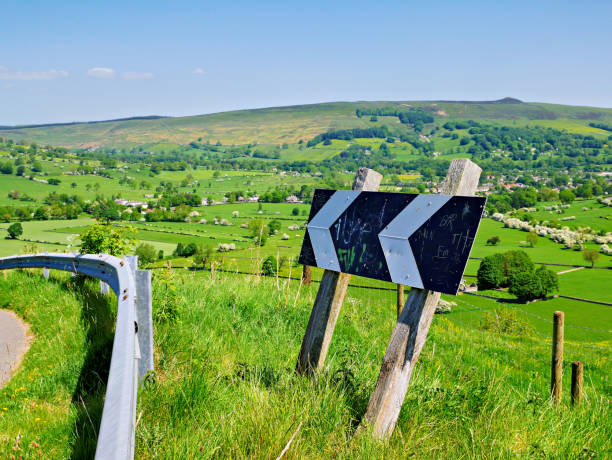 istock Chevron Directional Road Sign by the kerbside in Rural Fields and hills UK. 1493977696