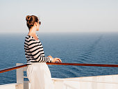 Stylish woman standing on the empty deck