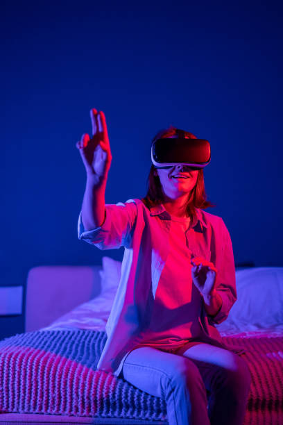 istock Young amazed millennial girl wearing metaverse VR headset touching objects in virtual world 1493982620
