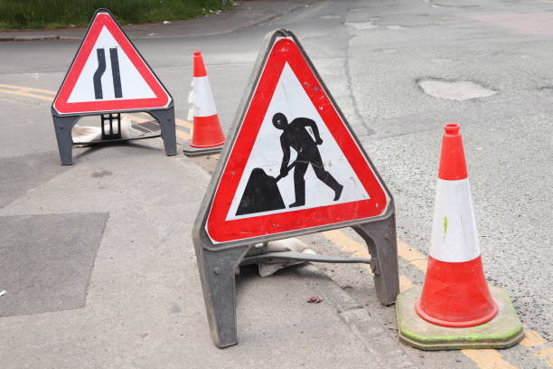 istock Digging road work sign and Road narrows on left ahead sign 1493983034