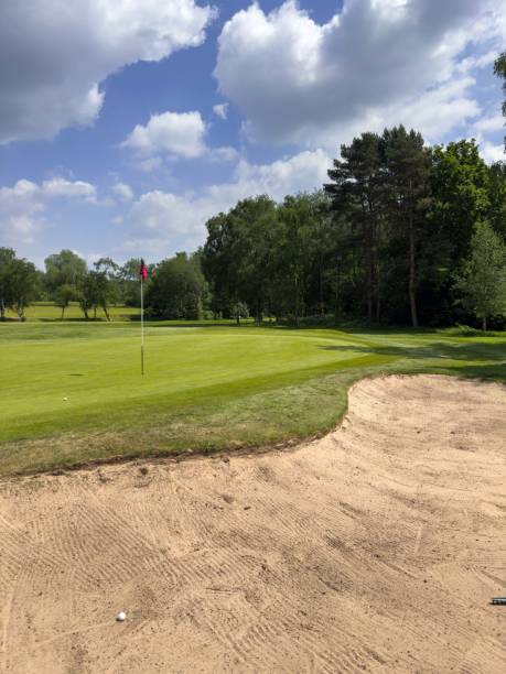 Flag and the hole at golf club blue sky summers day with some clouds