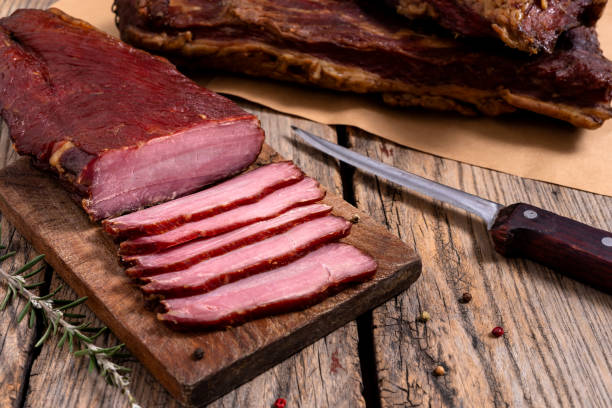 istock Dried meat on a wooden cutting board 1493983812