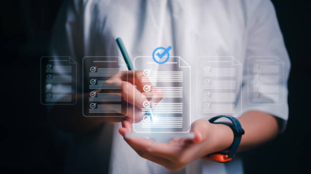 istock Women using smartphones with virtual screens and documents for online approval paperless quality assurance and ERP management concepts. 1493987844