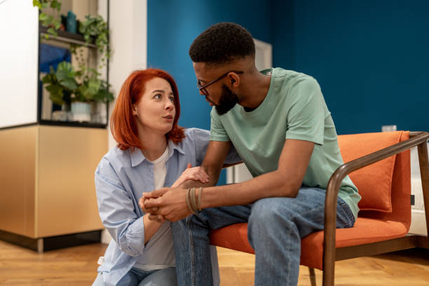 istock Young interracial married couple having intimate talk at home, discussing marital problems 1493987999