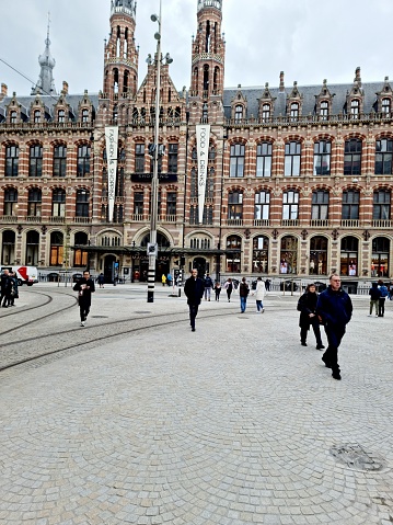 The Former Amsterdam Main Post Office, now the Magna Plaza shopping centre, is a monumental building realized between 1895 and 1899 in neo-Gothic and neo-Renaissance style. The image shows the main facade captured during spring season.