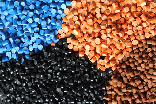 Multi colored heaps of molding compounds plastic pellets