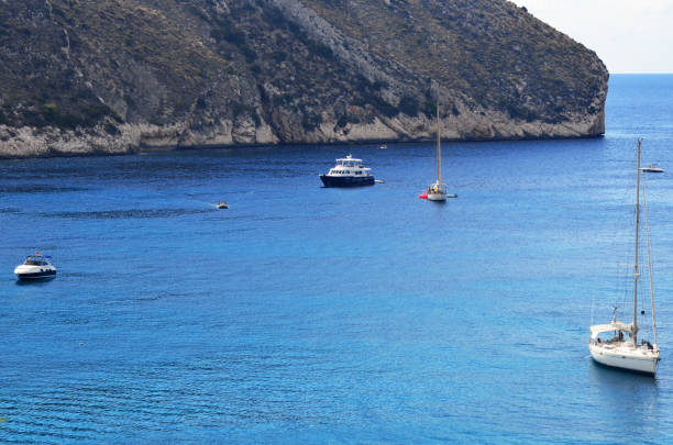 istock A sea bay with yachts and a rock behind them 1493990603