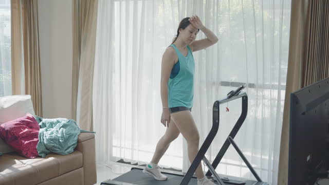 Woman Running on Treadmill and exercise at gym at home
