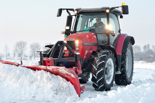 Tractor cleaning snow in field