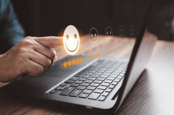 istock Customer pointing finger at smiley face emoticon and five-star symbol on virtual screen. Customer service evaluation concept. experience satisfaction, Service Score Survey, Good review. 1494002256
