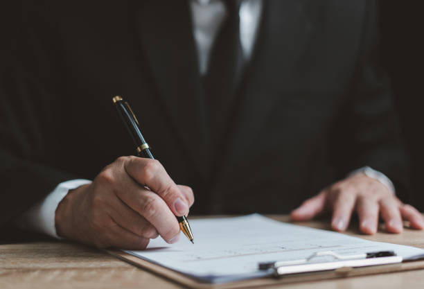 istock Businessman checking and certifying documents on the desk. Surveys, statistical reports, business contracts, and contract agreements. 1494002271