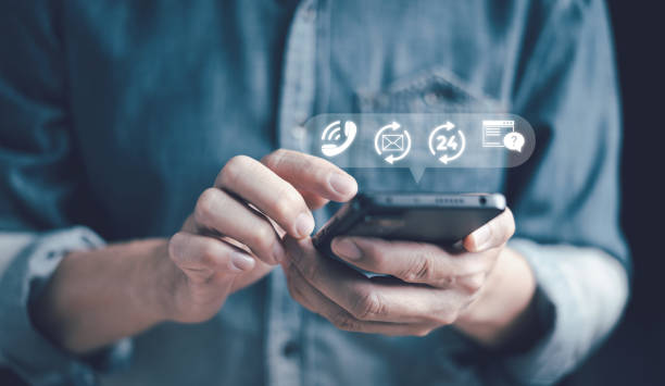 istock Contact us, customer service, and support hotline where people are connected 24/7. Customers use smartphones to contact via email, phone, chat, address, call center service, and help desk. 1494002360