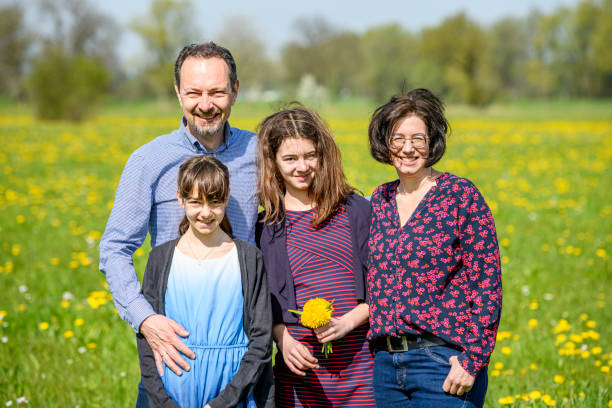 istock Happy family standing in a meadow 1494013713