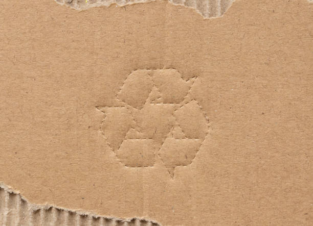 istock recycle symbol on brown cardboard paper background 1494013814