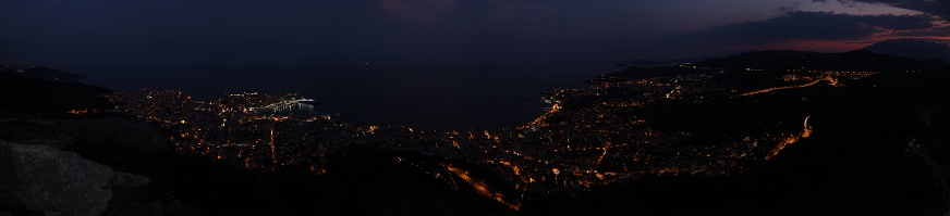 A stunning view of the sea and the coastal city of Kavala, Greece at night