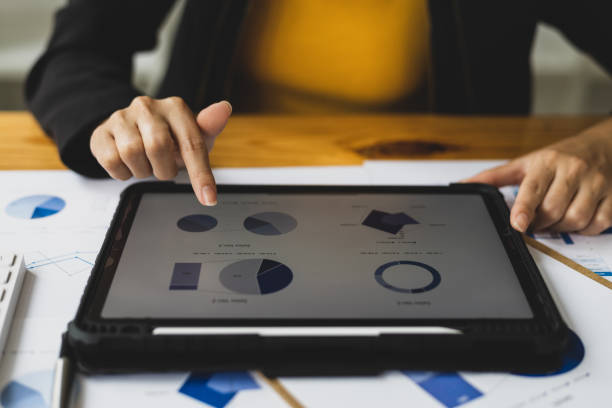 istock Businesswoman analyzing financial statistics displayed on the tablet screen, working data document graph chart report marketing research development planning management strategy accounting. 1494018981