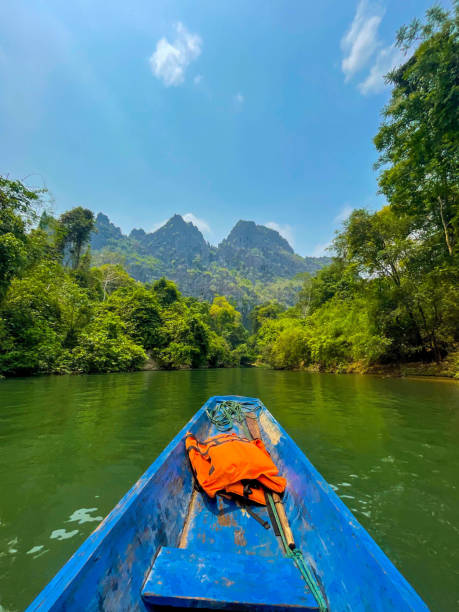 istock Blue canoe kayak with green mountains in the background, Thakhek loop, Laos 1494019525