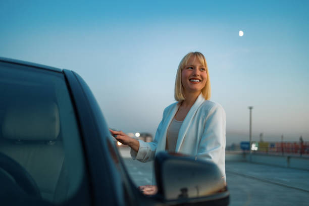 istock Young woman getting into car 1494021210