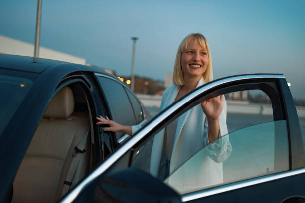 istock Young woman getting into car 1494021220