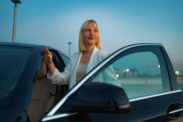 istock Young woman getting into car 1494021240