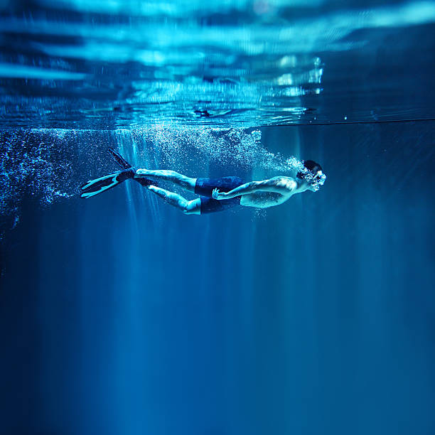 istock Man snorkeling on blue background, underwater view 149402287