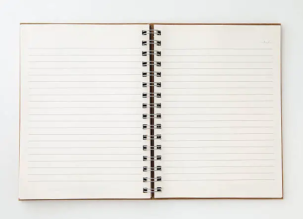 An open spiral bound notebook with lined paper