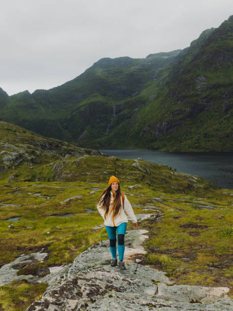 istock Woman backpacker contemplating summer outdoors on Lofoten Islands 1494024882
