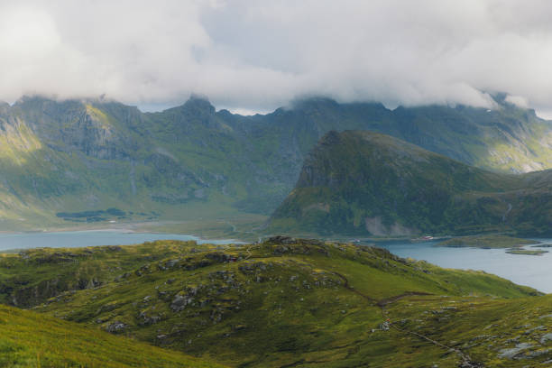 Scenic high-angle view of the turquoise-colored beach surrounded by the green mountain peaks, view from Ryten mountain on Lofoten, Nordland, Northern Norway