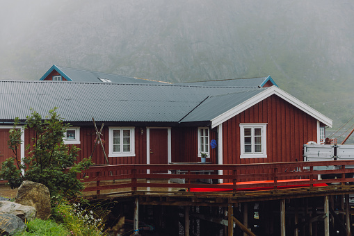 A view of old-fashioned fisherman's house to the seashore during summer rainy day on Lofoten, Northern Norway