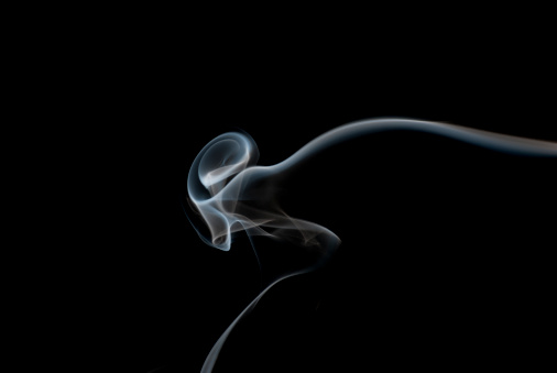 Abstract image of smoke in the shape of an ear. Could be used as an image depicting music and sound.