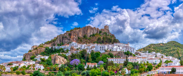 Zahara de la Sierra, one of the famous white villages in the province of Cadiz in Spain. Panoramic view of Zahara de la Sierra, one of the famous white villages in the province of Cadiz in Spain. ancient villages stock pictures, royalty-free photos & images