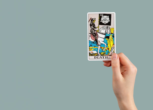 Death, tarot card in hand. Banner background with copy space for text Death, tarot card in hand. Banner background with copy space for text. skeloton hand stock pictures, royalty-free photos & images