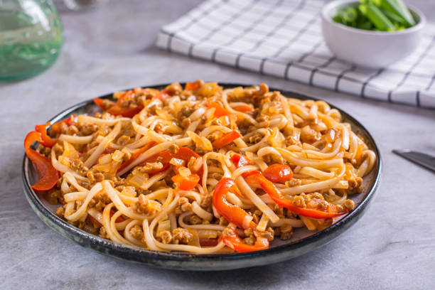 istock Udon noodles with soy meat and vegetables on a plate on the table 1494034751