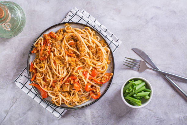 istock Udon noodles with soy meat and vegetables on a plate on the table top view 1494035297