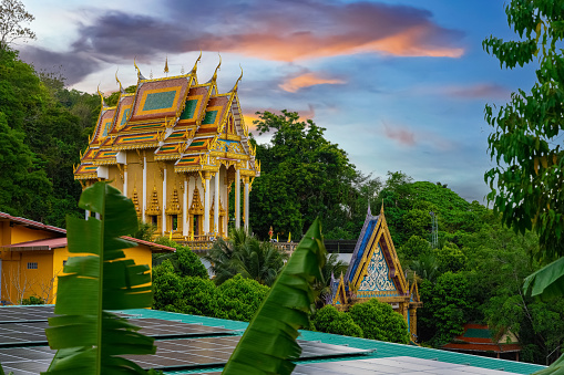 Beautiful Wat Buddhist temples in Old Phuket town Thailand. Decorated in beautiful ornate colours of red and Gold and Blue. Lovely sunset